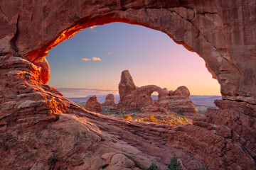 North Window Arch, Arches National Park, Utah, USA. Landscape image of North Window Arch, Arches National Park, Utah, USA with Turret Arch in the background at autumn sunset. © rudi1976