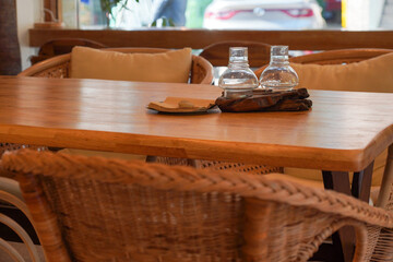 a table with a glass bottle for lighting candles