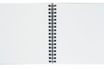 close up of opened sketch book with spiral bound against white