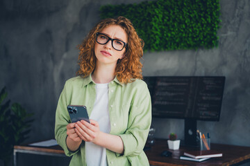 Photo of tired overworked lady coder wear shirt eyeglasses getting messages modern device indoors...