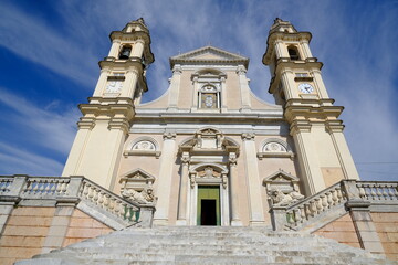 Ligurian city. Staircase with lion sculptures.White marble statues in front of the church of Santo Stefano. Italy