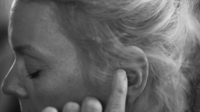 woman with deafness and hearing loss on grey background with people stock image stock photo