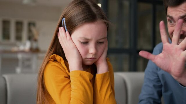 Anxious Caucasian girl little kid closing ears ignore angry dad man guy family argument stress abuse at home annoyed male father parent shout yelling offended child daughter conflict domestic problem