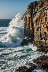 rocky cliffs with waves crashing below.