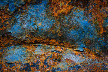 Rusty metal surface with shabby background paint. Blue cracked paint texture on an iron sheet. Fragment of an old metal door, Metal corrosion.