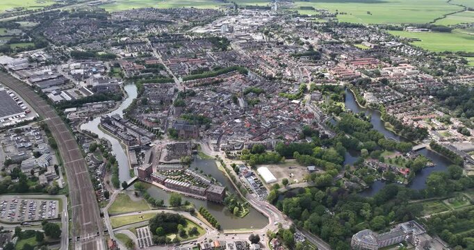 Drone flying above the historical city center of Woerden on a sunny day in Utrecht, The Netherlands
