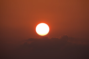 Closeup of bright big sun on the sky with yellow orange gradient colors during the sunset