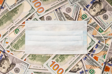 Government procurement of medicines concept . Face mask with American Dollar banknotes