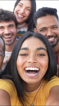 Multiracial friends taking selfie video with smart mobile phone outside - Happy young people having fun talking on city street - Life style concept with guys and girls hanging out on a sunny day	
