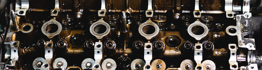 Disassembled car engine in oil. Cylinder head of an automobile engine. Inside the car being...