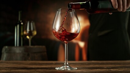 Detail of Red Wine Pouring, Sommelier Holding the Bottle.