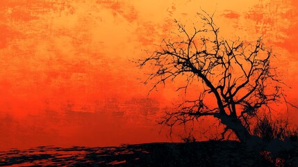 Obraz premium A striking silhouette of a barren tree against a vivid orange sunset, creating an atmospheric and dramatic backdrop.