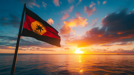 Serene Sunset View of the Kiribati Flag Silhouetted Against a Colorful Sky in an Ocean Landscape