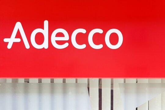 Belleville, France - September 29, 2024: Adecco logo on a wall. Adecco Group, based near Zurich, Switzerland, is the largest staffing firm in the world	