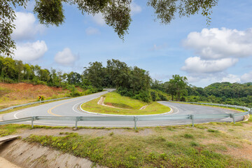 Popular view point of U-curve road up to the hill with Green tree and sky at Nan province, Northern of Thailand