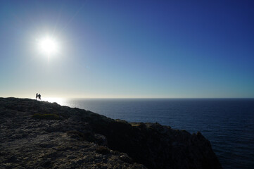 silhouette of a person on the top of the mountain