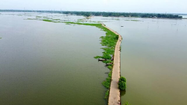 Drone arial view of Jamuna river Bangladesh, boat, ship, bulkhead moving through the river, life of riverbank people, 