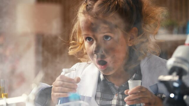 Funny schoolgirl shocked by chemical explosion smoke after failed lab research