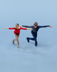 Confident and synchronized pose from young figure skating duo, highlighting their competitive...