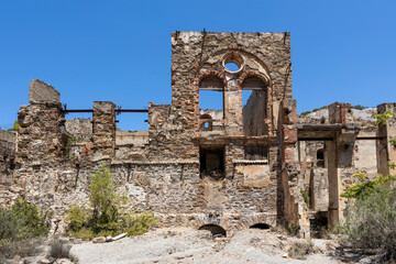 Ruins of an old stone building under a clear sky