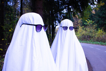 Ghost costume for Halloween. DIY festive outfit. Photo of ghosts in the autumn forest, with a...