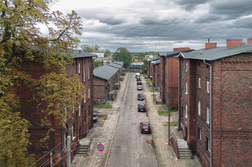 Obraz premium Old residential red brick houses built for railroad workers on Krótka street in Krzyż Wielkopolski, Poland. Autumn view