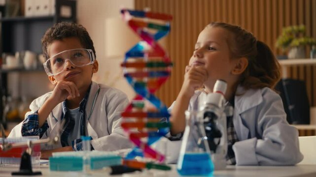 Two funny kids in lab coats thinking about research, having a brilliant idea