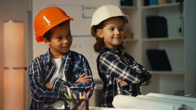Portrait of little girl and boy in construction hats playing as engineers