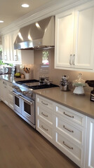 Fototapeta premium White kitchen cabinets with stainless steel appliances and a brown countertop.