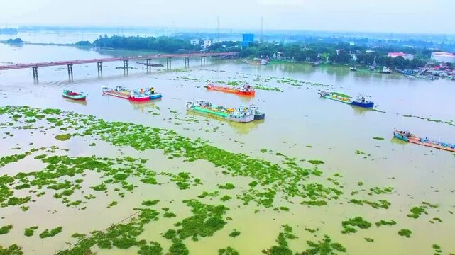 Drone arial view of Jamuna river Bangladesh, boat, ship, bulkhead moving through the river, life of riverbank people, 