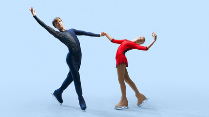 Fototapeta premium Impressive figure skating lift, showcasing the strength and grace of the skaters against cold blue background. Artistry in ice dance. Concept of winter sport, elegance and grace, championship. Ad