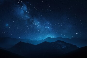 A starry night sky with mountains in the background