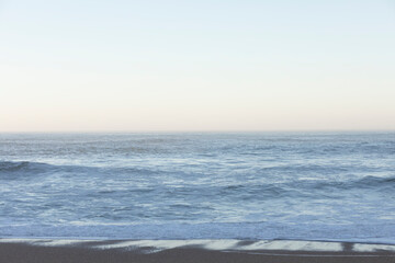 Fototapeta premium Beach and sea background, view of the Atlantic ocean, from a city in Europe.