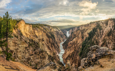 Yellowstone National Park sunset at Artist Point Overlook with view of Lower Falls at Grand Canyon of the Yellowstone River 