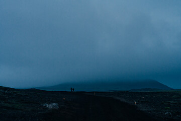 Epic panorama of Icelandic highland landscape: black volcanic mountains covered with soft green moss