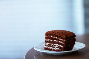 A delicious slice of rich chocolate cake elegantly presented on a white plate