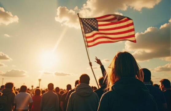 People gathered under a vibrant sunset, celebrating freedom while waving an American flag in a moment of unity and pride