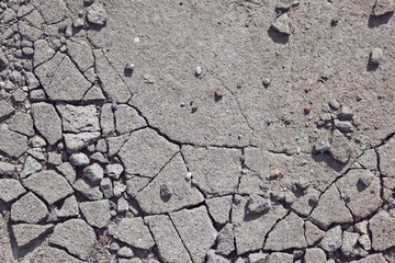 Obraz premium texture of cracked concrete or asphalt, graphic contrast pattern in bright sunlight