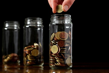 saving coins with money to pay bills having the intention of calculating raising more money to be wealthy stock image stock photo	