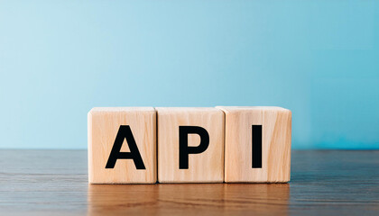 Wood cubes with abbreviation text API on wooden table. Application Programming Interface.