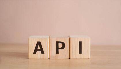 Wood cubes with abbreviation text API on wooden table. Application Programming Interface.
