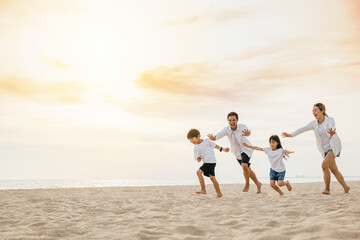 A vibrant scene on the beach with a smiling father happy mother and children playing running and laughing. Quality family time carefree moments and happiness during their summer holiday.