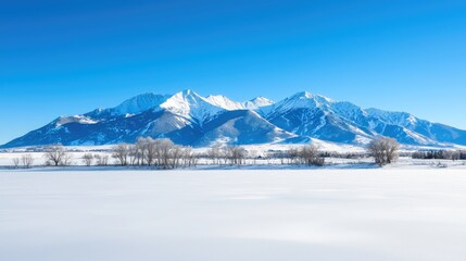 Fototapeta premium Serene Snow-Covered Mountain Range Under Clear Sky