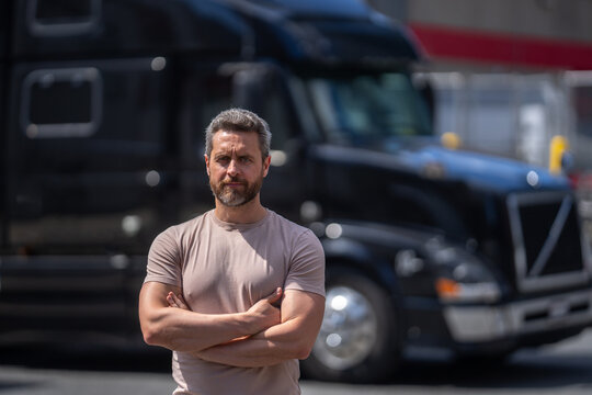 Truck driver. CDL. Portrait of trucker standing by his truck vehicle ready for transport. Male driver standing in front on his truck. Men driver near lorry trucks. Man owner truck driver. Millennial