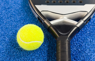 Paddle racket with a ball ready to play the fastest growing sport in recent years worldwide. Padel...