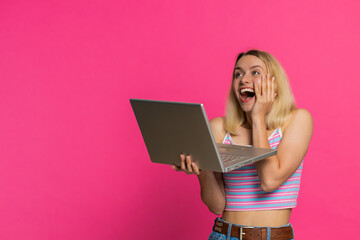 Happy excited Caucasian woman typing on laptop, working on project, enjoying results, winning...