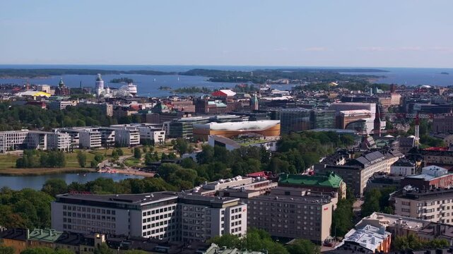 Aerial view panning over the city center of Helsinki, Finland. The camera reveals the cityscape with its Central Library Oodi