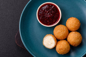 French fries balls with breaded brie or camembert cheese with sweet berry sauce