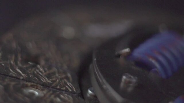 Automobile clutch disc. Friction surface. Passenger car. Manual transmission. Car part. New spare part. Review. Video shooting in the studio. Close-up. Macro.