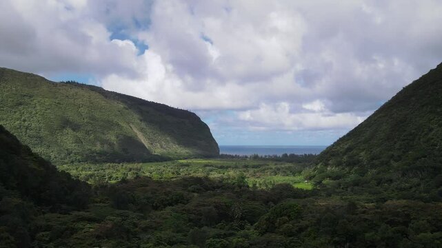 Aerial view of the Waipio Valley on the Big Island of Hawaii with its beautiful waterfalls shrouded in fog and clouds.